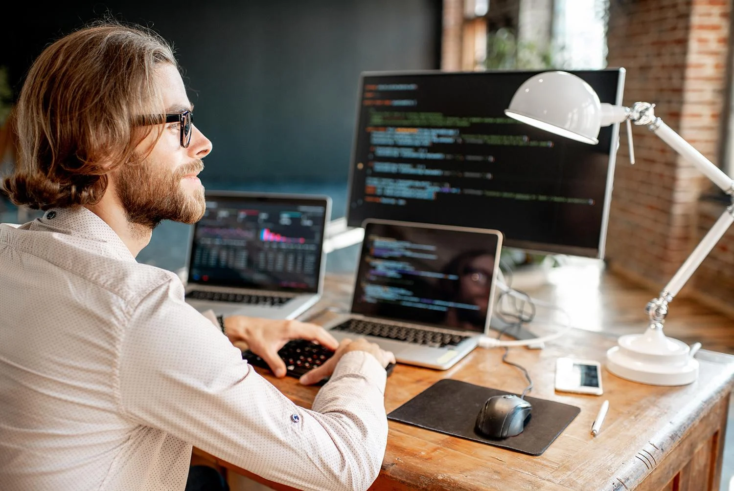 Programmer writing code on computer